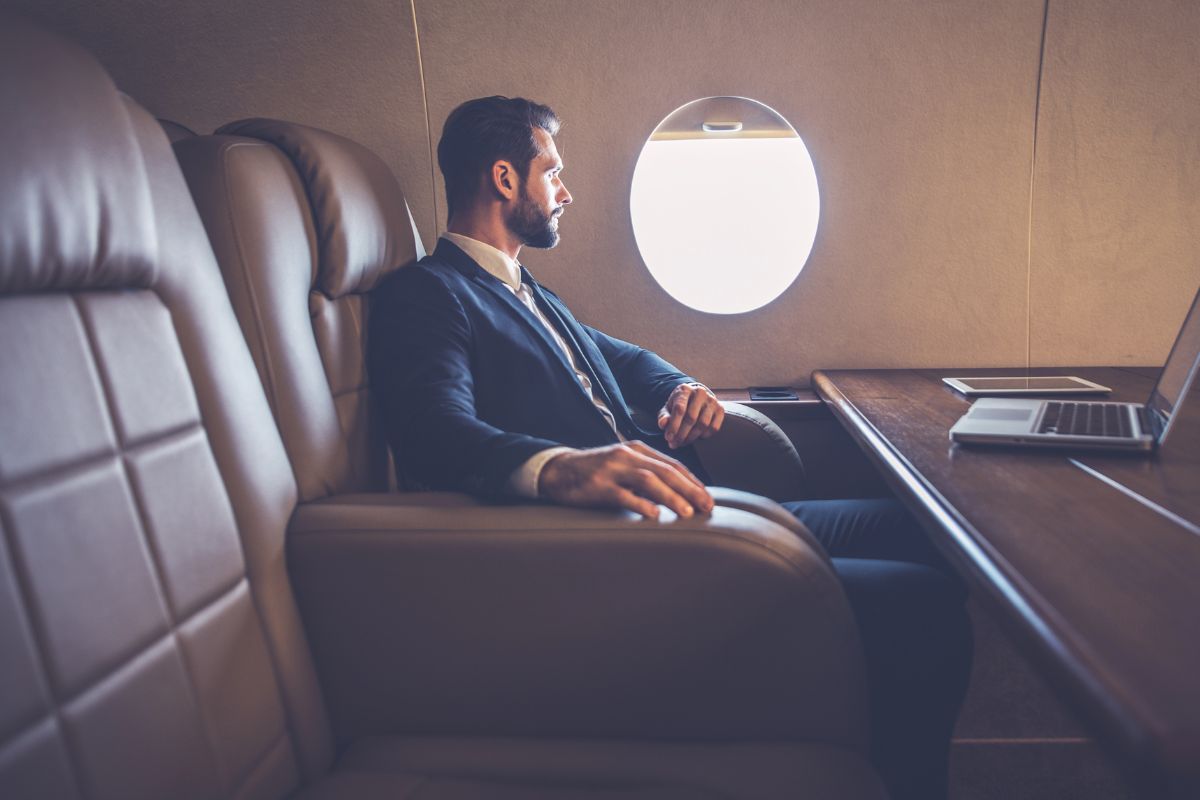 Interior cabin of a heavy jet configured for business, featuring a conference table, executive seating, and high-speed connectivity for in-flight productivity.